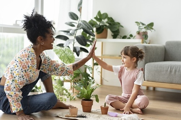 multiracial family high five while indoor gardening